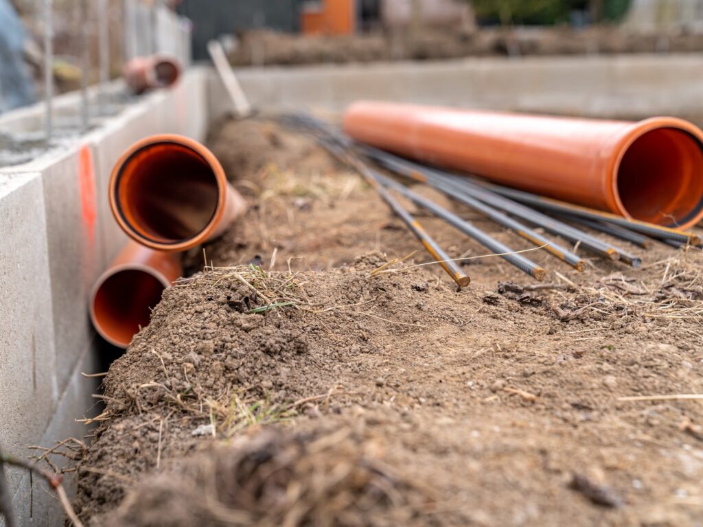 Sewage network pipework installed in the base slab at a construction site