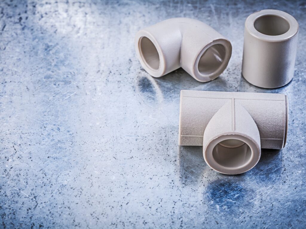 UPVC pipe connectors and couplers laid out on a metal work surface